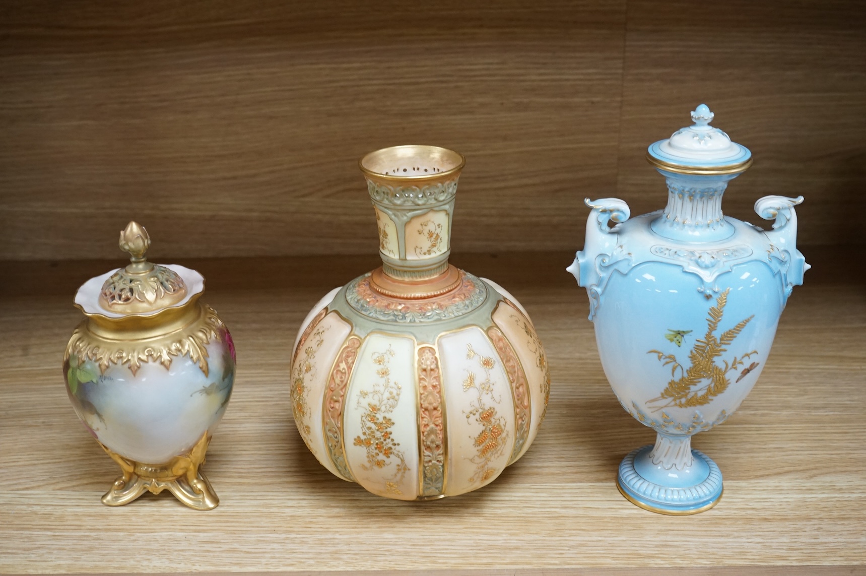 A Royal Worcester vase and cover, shape 1618 decorated with ferns and insects, a similar blush ivory bottle vase and a pot pourri vase and cover decorated with roses, tallest 24cm